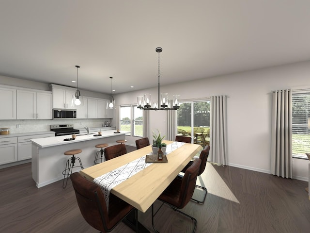 dining area featuring dark hardwood / wood-style floors, a chandelier, and sink