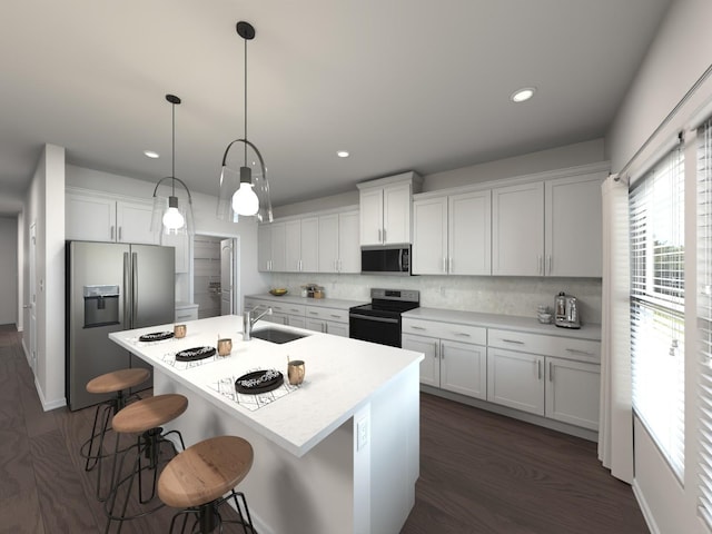 kitchen featuring stainless steel appliances, white cabinetry, sink, and decorative light fixtures