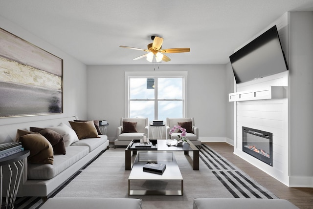 living room with dark hardwood / wood-style floors and ceiling fan