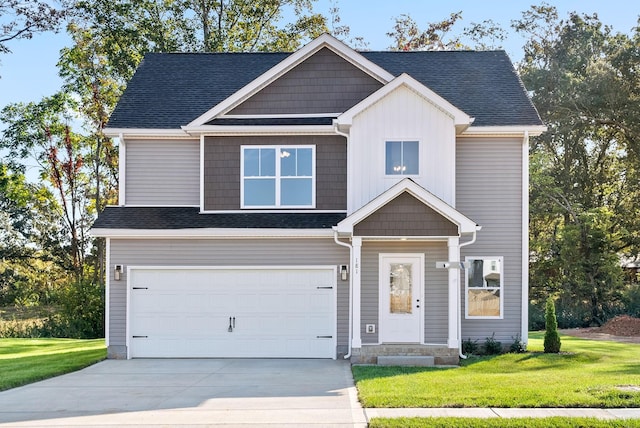 craftsman-style house featuring a garage and a front yard