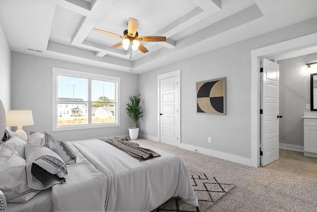 bedroom with light colored carpet, a raised ceiling, and ceiling fan