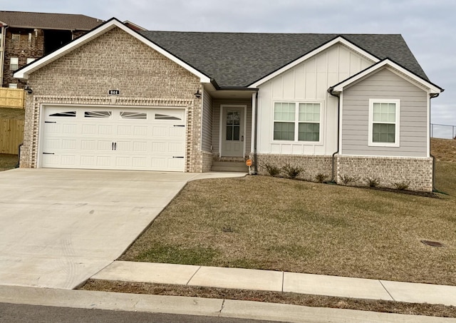 view of front of house with a garage and a front lawn