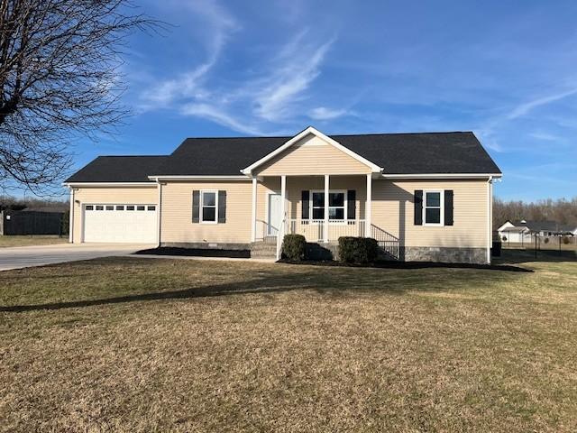 single story home featuring a garage, a front lawn, and covered porch