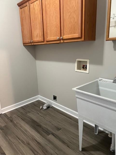 laundry area with cabinets, sink, dark hardwood / wood-style floors, and washer hookup