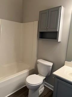 full bathroom with vanity, toilet, shower / bath combination, and wood-type flooring