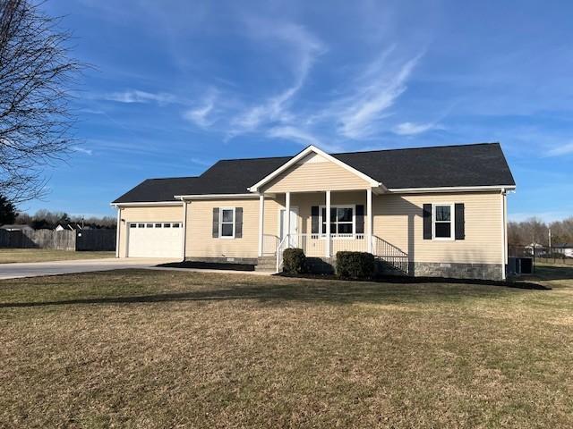 ranch-style home with a porch, a garage, and a front lawn