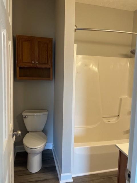 full bathroom featuring vanity, wood-type flooring, toilet, and washtub / shower combination