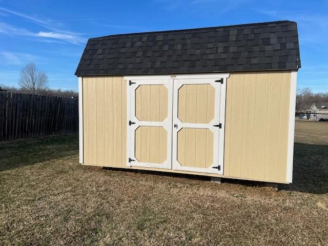 view of outbuilding with a yard