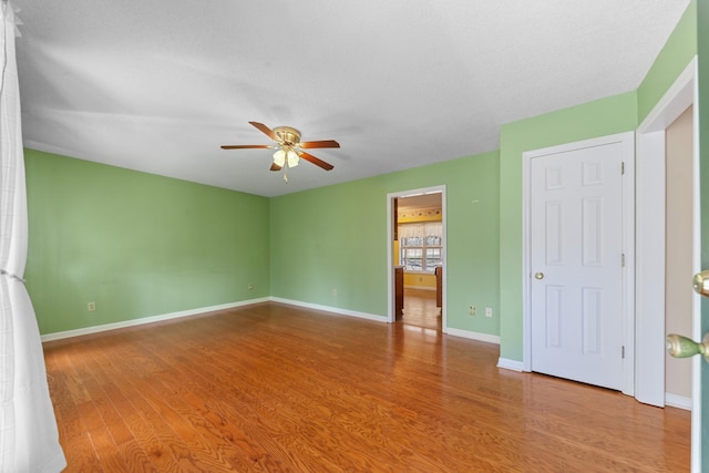 unfurnished bedroom featuring hardwood / wood-style flooring, a textured ceiling, and ceiling fan