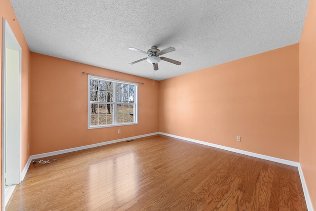 unfurnished room featuring ceiling fan, a textured ceiling, and light wood-type flooring