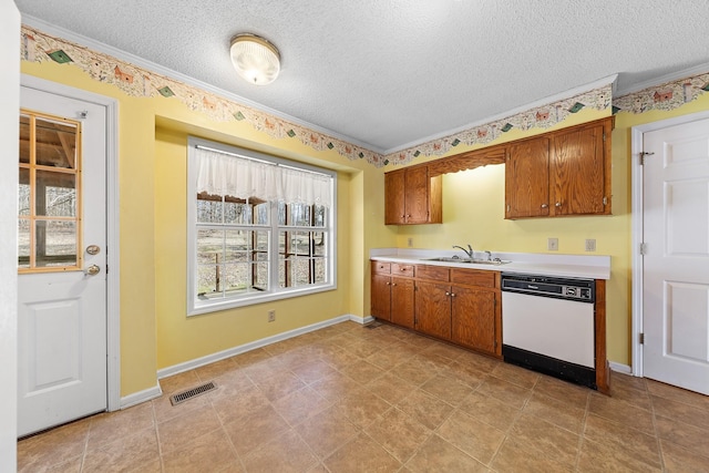 kitchen featuring dishwasher, sink, a textured ceiling, and crown molding