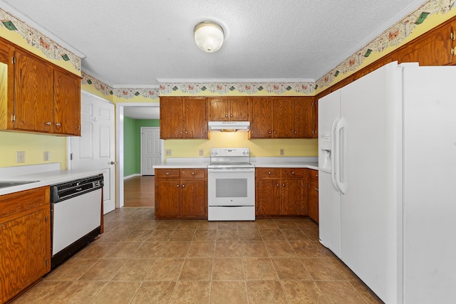 kitchen with white appliances, ornamental molding, and a textured ceiling