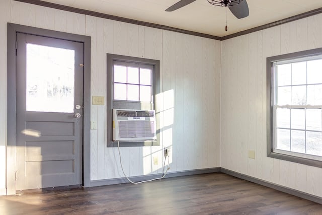 interior space featuring wooden walls, cooling unit, ceiling fan, crown molding, and dark wood-type flooring