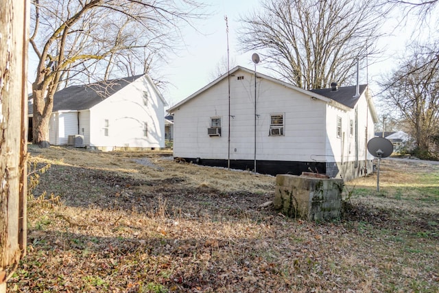 rear view of property featuring central AC and cooling unit