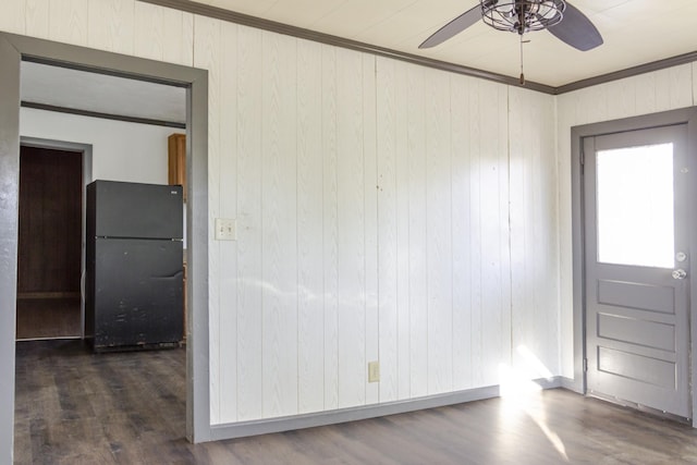 foyer with crown molding, dark hardwood / wood-style flooring, and wood walls