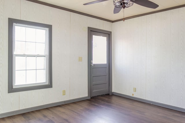 unfurnished room featuring crown molding, ceiling fan, and dark hardwood / wood-style floors