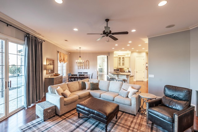 living room with hardwood / wood-style flooring, ornamental molding, and plenty of natural light