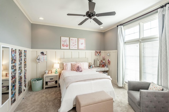 carpeted bedroom with ceiling fan and ornamental molding