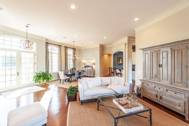 living room featuring crown molding, french doors, a chandelier, and hardwood / wood-style flooring