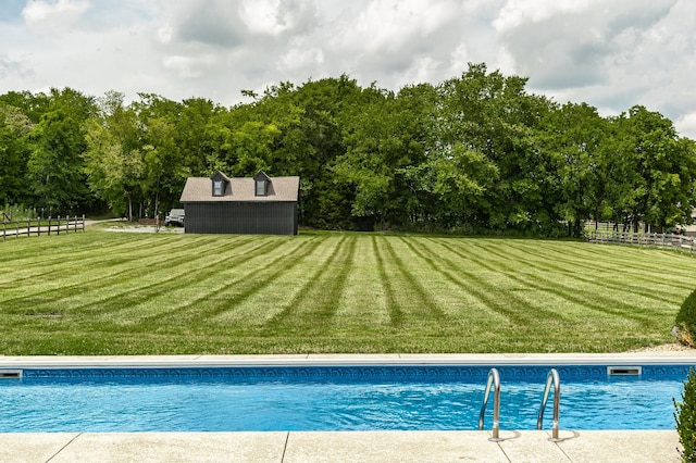 view of pool featuring a yard and an outdoor structure