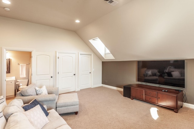 living room with vaulted ceiling with skylight and light carpet