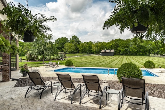 view of pool with a yard and a patio area