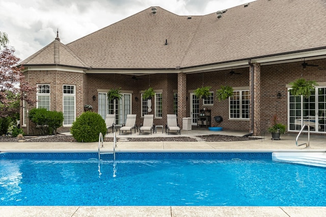 view of pool with a patio and ceiling fan