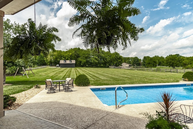 view of swimming pool with a patio and a lawn