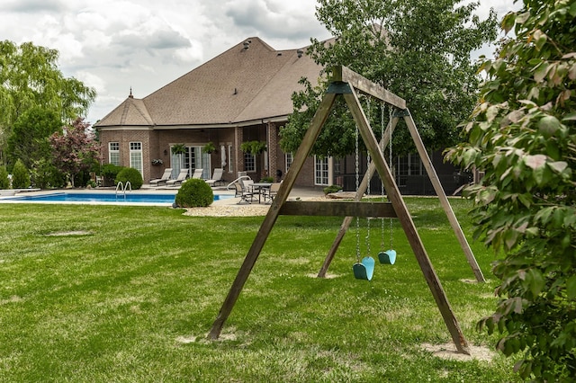 view of play area with a lawn and a patio area