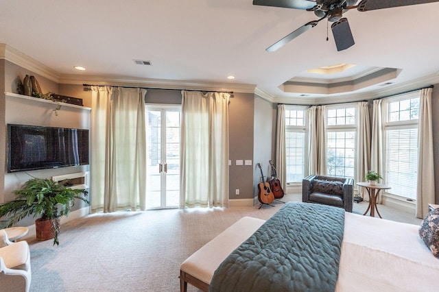 bedroom with ornamental molding, light colored carpet, access to exterior, ceiling fan, and a tray ceiling