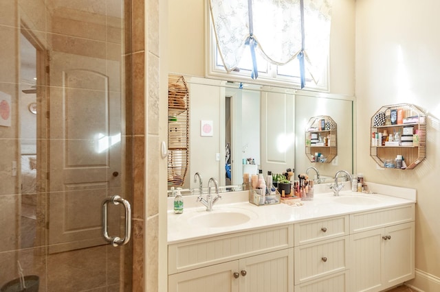 bathroom featuring an enclosed shower and vanity