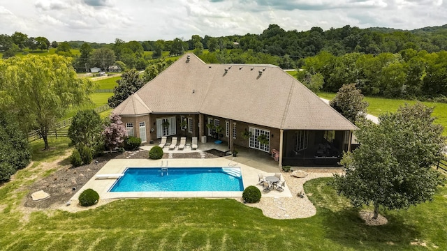 view of pool with french doors, a diving board, a yard, and a patio area