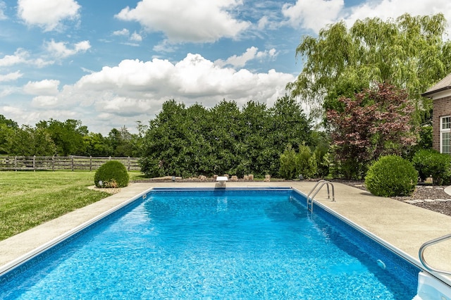 view of pool featuring a lawn