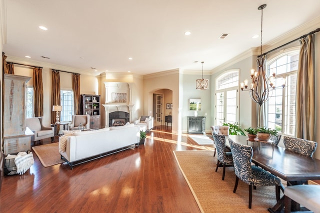 living room with crown molding, a notable chandelier, and dark hardwood / wood-style flooring