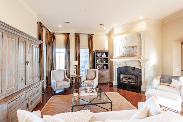 living room featuring crown molding, dark wood-type flooring, and a fireplace