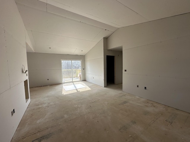 unfurnished room with lofted ceiling