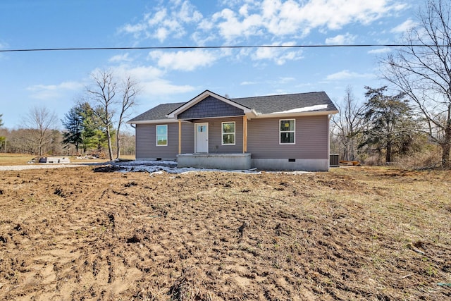 view of front of property with a shingled roof, crawl space, and cooling unit