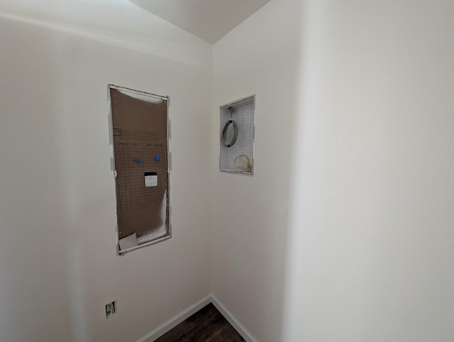 interior space featuring baseboards and dark wood-style flooring