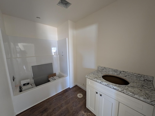 bathroom with wood finished floors and vanity