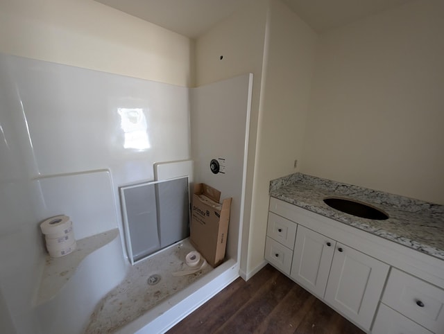 bathroom with wood finished floors and vanity