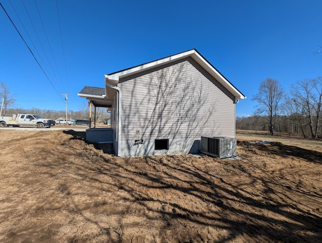 view of side of home featuring crawl space and central AC unit