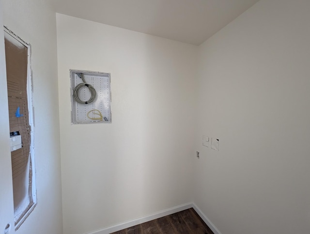 washroom with dark wood finished floors and baseboards