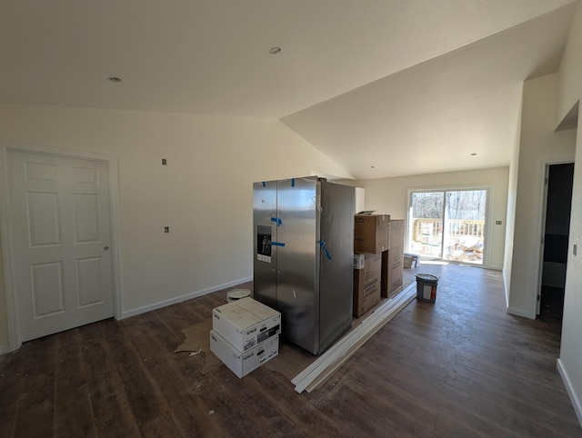 kitchen with vaulted ceiling, dark wood-type flooring, and baseboards