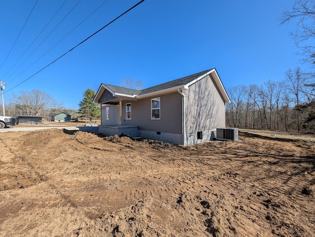 view of side of property featuring crawl space and central AC unit