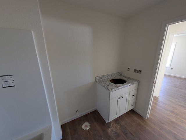 bathroom featuring wood finished floors, vanity, and baseboards