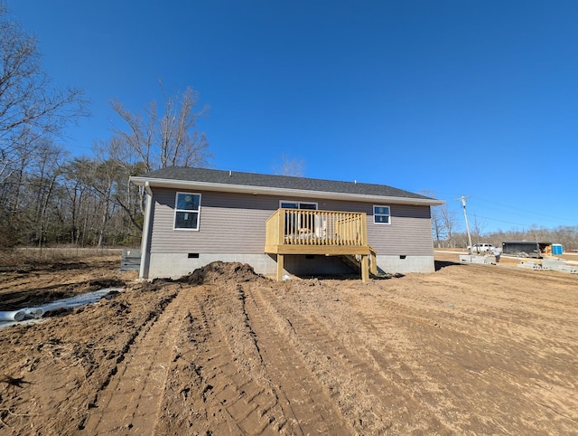 rear view of property featuring crawl space and a deck