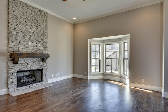 unfurnished living room featuring ornamental molding, a stone fireplace, dark hardwood / wood-style floors, and ceiling fan