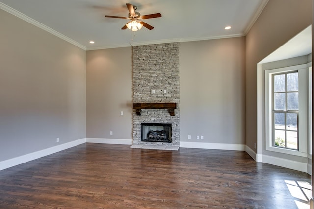 unfurnished living room with crown molding, a stone fireplace, dark hardwood / wood-style floors, and ceiling fan