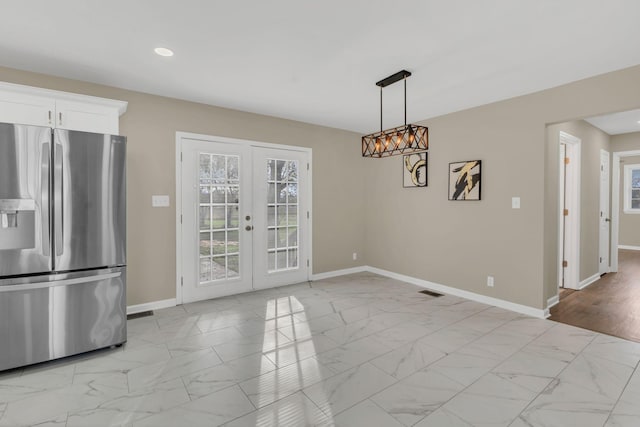 unfurnished dining area featuring french doors