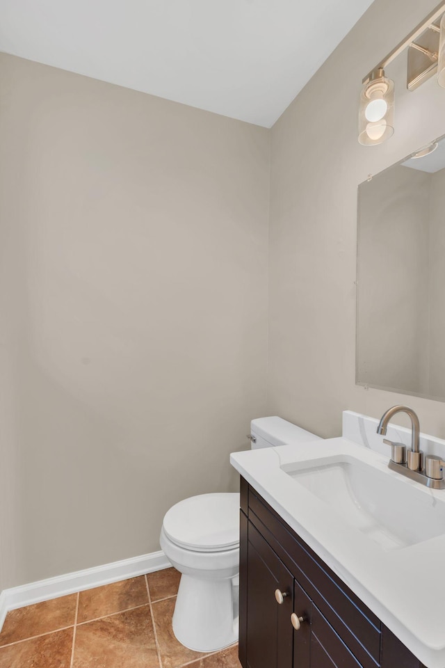 bathroom with vanity, tile patterned floors, and toilet